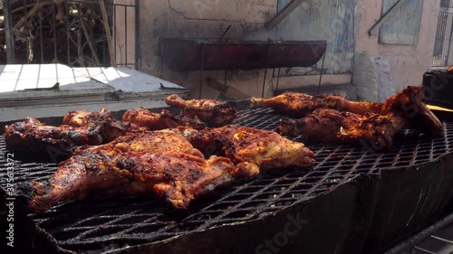 Close up shot of a jerk chicken on the grill. Caribbean street food. photo