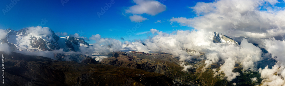Panorama of mountains and glaciers at Rothorn mountain, Zermatt, swiss alps, Switzerland (cloudscape with Matterhorn)
