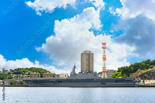 yokosuka, japan - july 19 2020: Wide angle view of the Japanese Destroyer JS Izumo DDH-183, an helicopter and aircraft carrier of Japan Maritime Self-Defense Forces berthed in the Yokosuka naval port. photo