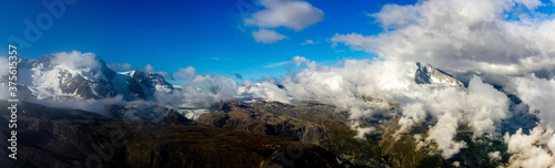 Panorama of mountains and glaciers at Rothorn mountain, Zermatt, swiss alps, Switzerland (cloudscape with Matterhorn)