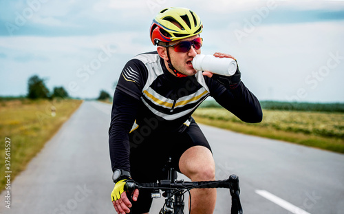 Hydration is important. Thirsty cyclist riding a bicycle. Sport and recreation concept