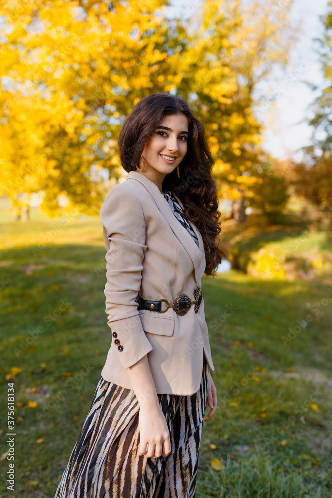 Close up portrait of a beautiful brunette girl with make up and in elegant fall outfit, posing in the park. Close up portrait of a beautiful brunette girl with make up and in elegant fall outfit, posing in the park.