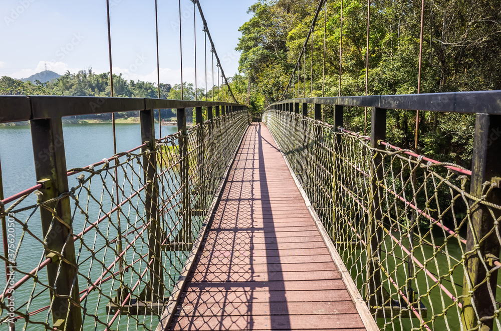 Obraz premium pond with suspension bridge at Toushe Reservoi