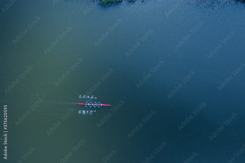 Boat coxed four rowers rowing on the river aerial drone top view - obrazy, fototapety, plakaty 