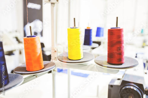 Colorful sewing threads spools at textile workshop