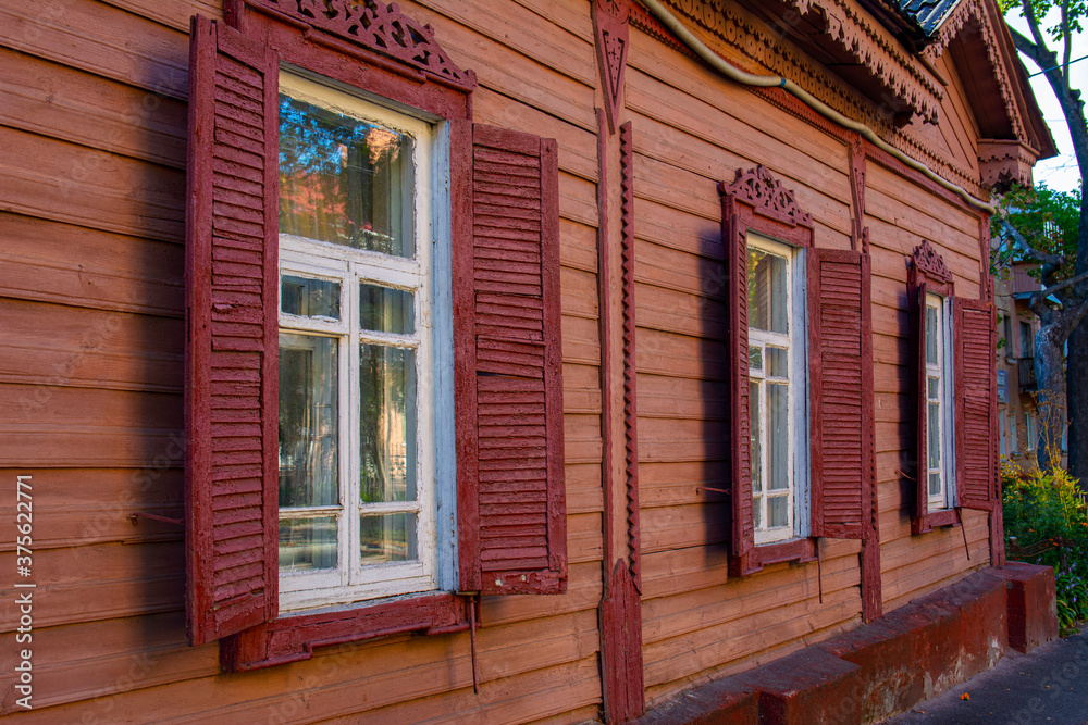 Windows of an old vintage wooden house in the afternoon on a sunny day