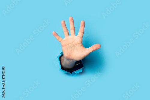 Men's palm on a blue background. Banner. Five fingers gesture