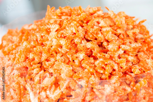 Dry shrimps of various sizes in the basket for sale in market.