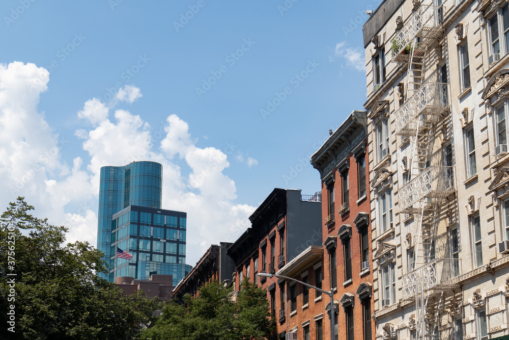 Row of Colorful Old Residential Buildings in the East Village of New York City with a Modern Glass Skyscraper