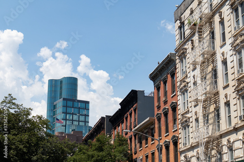Row of Colorful Old Residential Buildings in the East Village of New York City with a Modern Glass Skyscraper