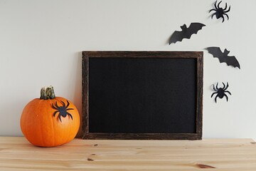 Halloween wooden blackboard mockup, empty wooden farmhouse sign for design, horizontal frame mockup, pumpkin and Halloween decorations.