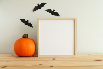 Square wooden frame mockup, Halloween decorations, pumpkin, blank frame for artwork, design, photo, print presentation. 