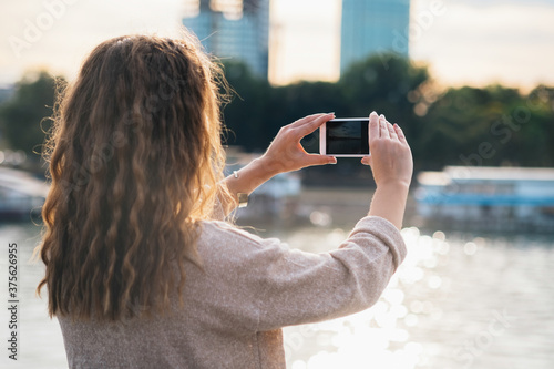 Woman taking photo with her phone stock photo photo