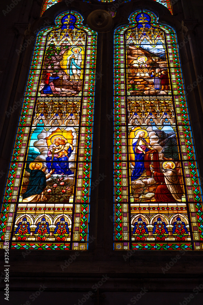 Saint- Antonin- Noble- Val, FRANCE 24.08.2020. Close-up of big colorful stained glass inside Catholic cathedral.