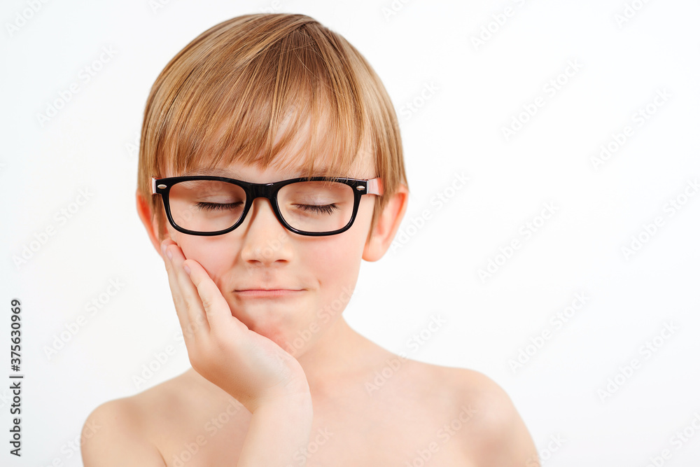 Sad child wearing glasses on white background. Childhood. Nerd little boy portrait. Sad child wearing glasses on white background. Childhood. Nerd little boy portrait.