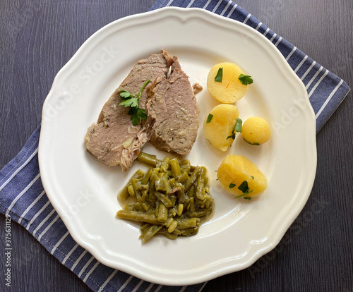 Boiled beef meat with dill cream green beans and boiled potatoes with parsley. Traditional Austrian dish.