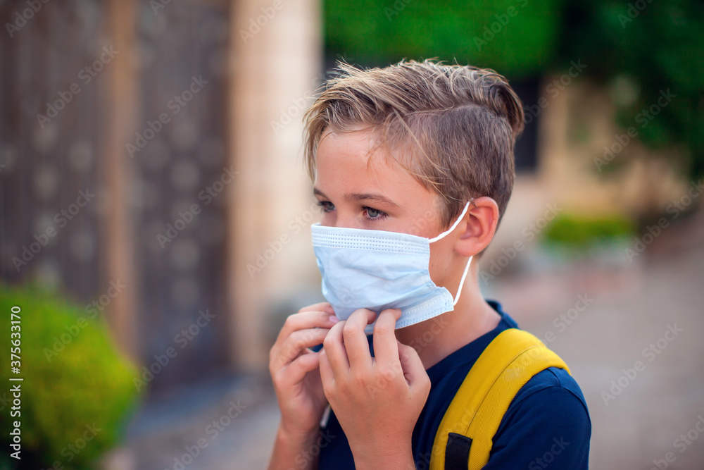 Pupil with face mask staying outdoor. Back to school. Pupil with face mask staying outdoor. Back to school.