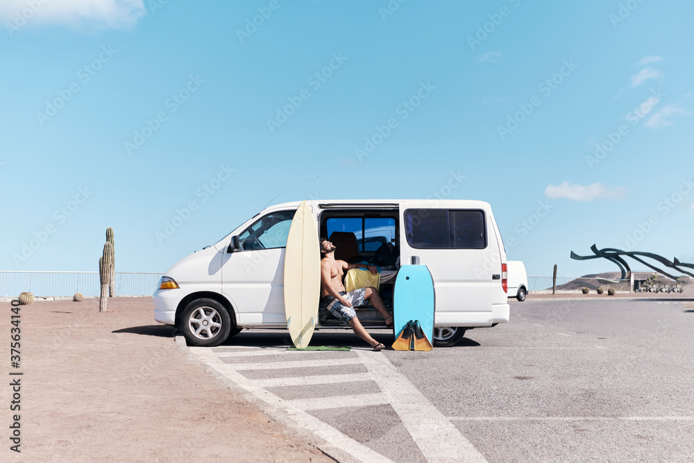 Man With Surfboards And Van