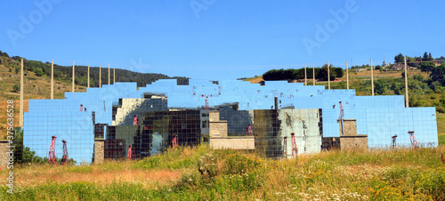 Odeillo solar furnace, France, the world largest solar furnace. Mirrors on a hillside reflect sunlight into the 54 meter high parabolic mirror  photo