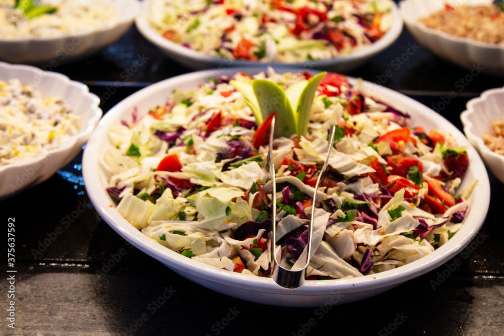 Catering food, salad in a white plate, buffet
