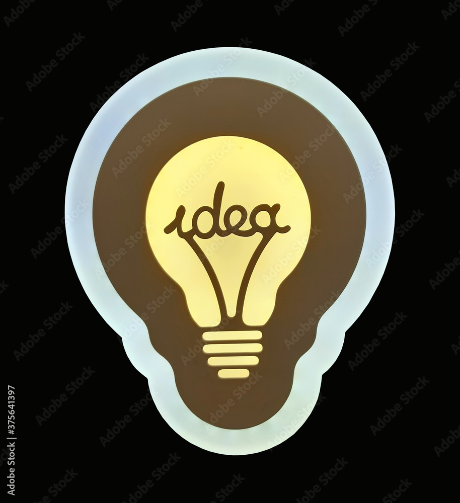 There is a light bulb with a word idea. Black background. Isolated. There is a light bulb with a word idea. Black background. Isolated.