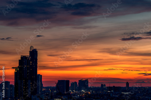 The high angle background of the city view with the secret light of the evening, blurring of night lights, showing the distribution of condominiums, dense homes in the capital community