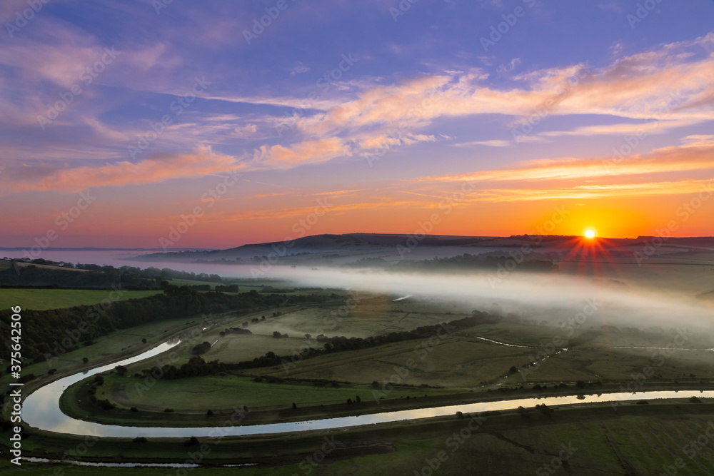 Sunrise over the south downs and morning mist of the cuckmere valley in east sussex south east England