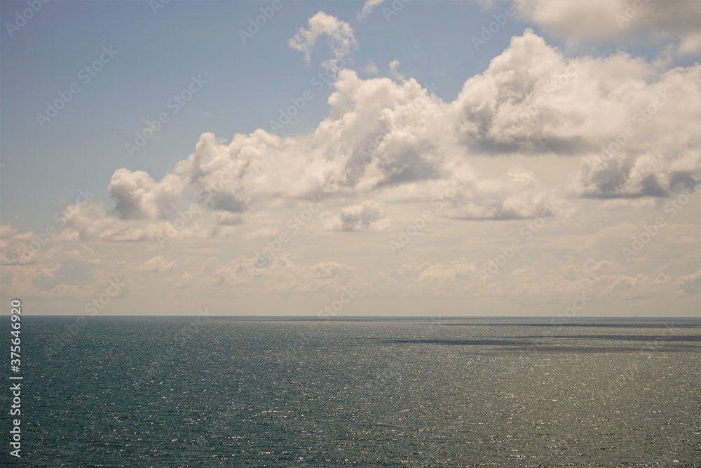 Fototapeta premium Bright blue sky with white cumulus clouds and skyline. Looks relaxation view for travelling to Atlantic ocean, concept of vacations, Summer in Myrtle beach, SC USA.