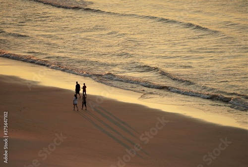 Top view of silhouette people with their shadow on the Myrtle beach   Sunrise in South Carolina USA.