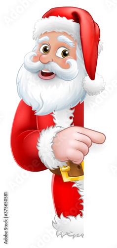 Santa Claus Christmas cartoon character peeking around the side of a sign background pointing at it with copyspace.