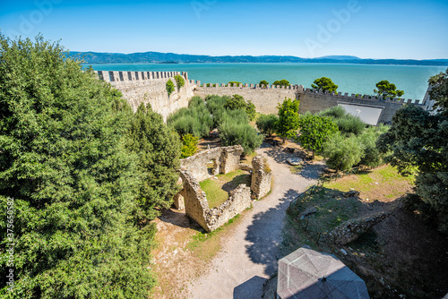 Castiglione del Lago fortress fort wall wide high angle view in Umbria, Italy Rocca Medievale del Leone by lake Trasimeno in sunny summer with old ruins