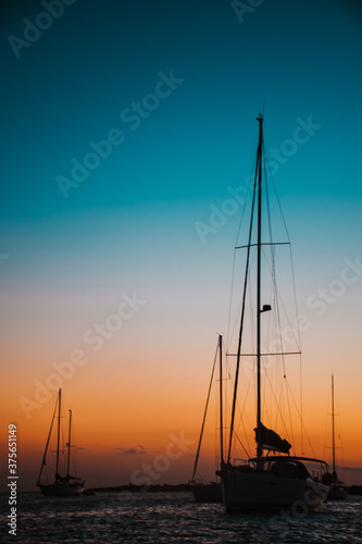 Anchored sailboats silhouette at sunset © Alex