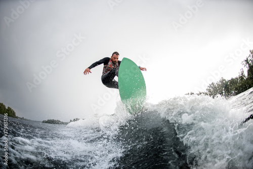 brave man jumping on bright wakeboard down the river water © fesenko