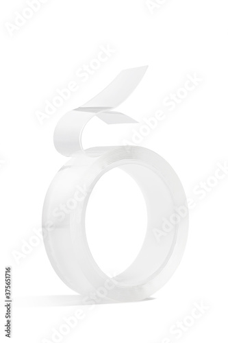 Detailed shot of double sided mounting tape for quick repair service and different surfaces sticking. The roll of clear adhesive tape is isolated on the white background.