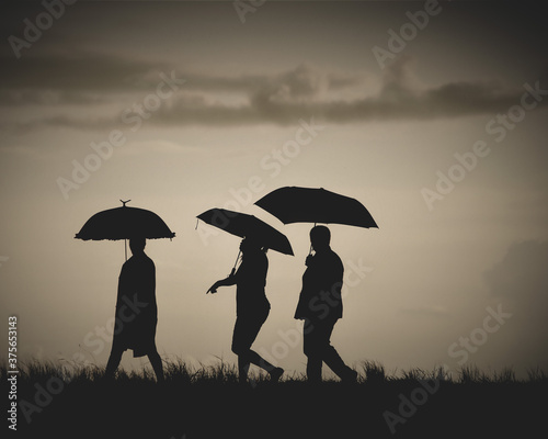 silhouette of a couple under umbrella