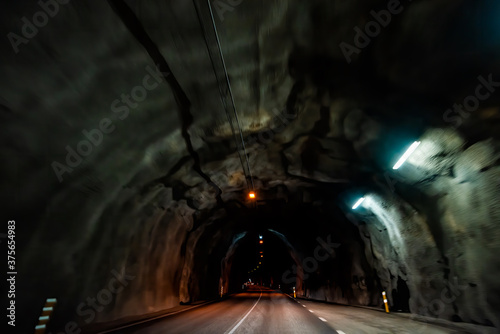 Almannaskard or Almannaskardsgong tunnel dark inside abstract view near Hofn, Iceland with lights path illuminated passage on ring road highway