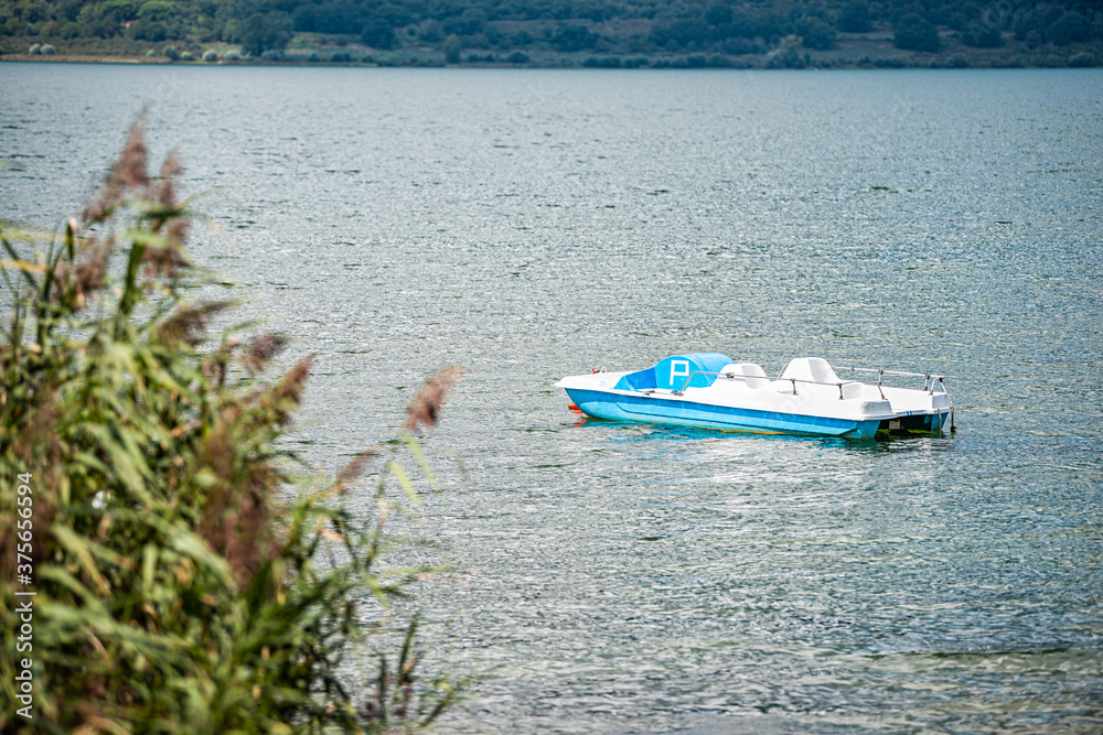 Obraz premium Punta del Lago with Vico lake Terni province and nobody landscape day view of blue water and peaceful water with blue boat