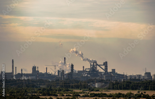 Industrial plant in the haze of smog exhaled pipes.