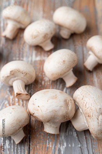 Heap of mushrooms on light wooden table, close up photo for a market catalogue