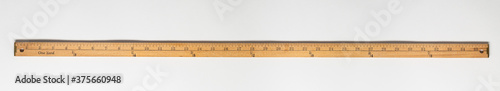Wooden yardstick on white backgrounds whit inches and yard fractions scales. photo
