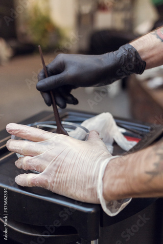 Close up of a hairdresser mixing haircolor together photo