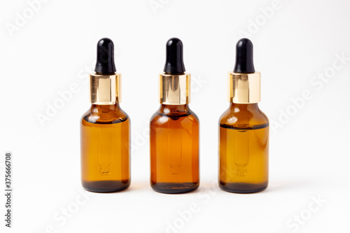 A set of amber bottles for essential oils and cosmetics. Glass bottle. Dropper  spray bottle