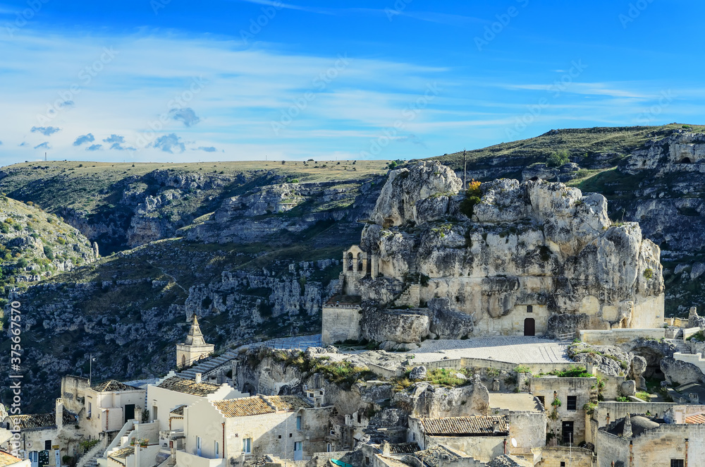 Φωτογραφία The sanctuary of Santa Maria de Idris is dug into the rock overlooking the Sasso Caveoso, on which stands a large wrought iron cross