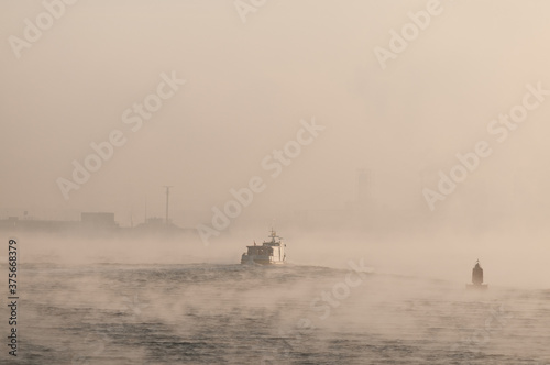 ship in the fog on the river Maas, port of Rotterdam. photo