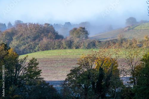 Frosty fields and village church in Oxfordshire on a sunny autumn day