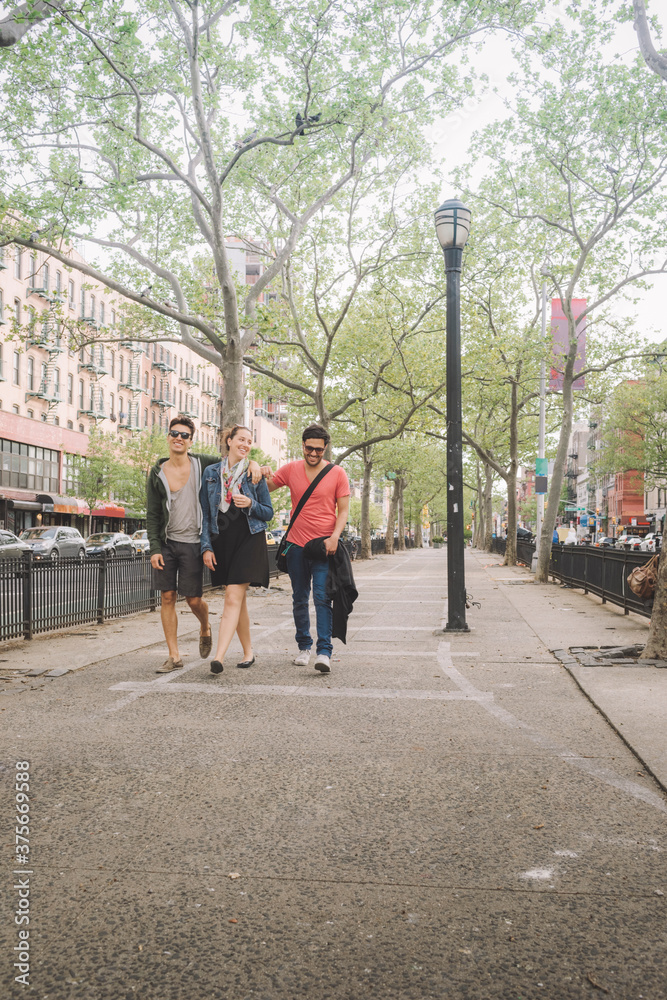 Three Friends in Casual Walking Leisurely in New York Lower East Side Three Friends in Casual Walking Leisurely in New York Lower East Side