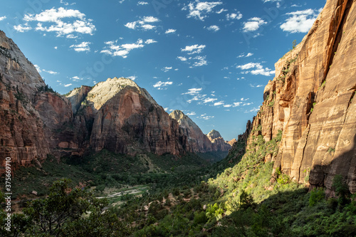 View over Zion canyon with a blue sky filled with white clouds taken from the trail to Angels' landing on a hot summer day - Zion National Park, UT - USA