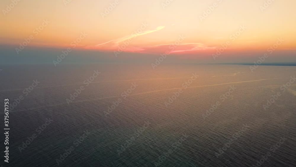 Amazing sunset on the sea in summer time. Beautiful orange colors of the sky and clouds and sea touching in horizon Amazing sunset on the sea in summer time. Beautiful orange colors of the sky and clouds and sea touching in horizon