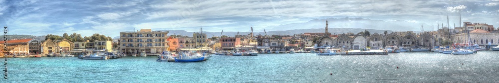 A panorama view of the entrance to the main harbour and marina in Chania, Crete on a bright sunny day