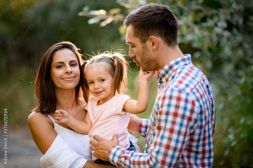 portrait of handsome family couple with little cute daughter portrait of handsome family couple with little cute daughter